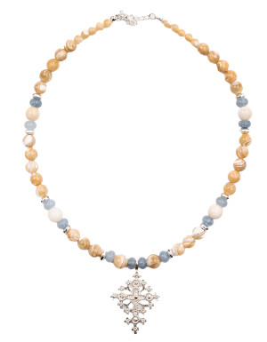 A blue-beige necklace with a silver cross