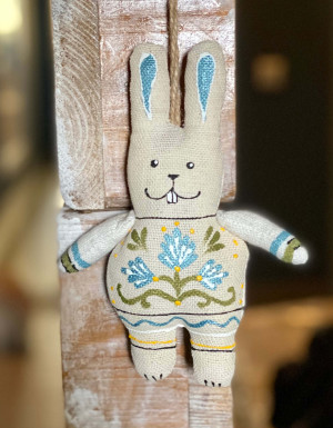 Hare with paws with blue flowers