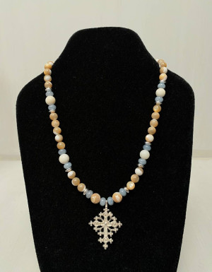 A blue-beige necklace with a silver cross