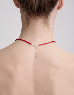 Necklace from burgundy coral, silver bird