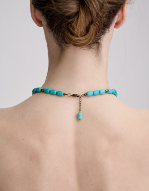 Handmade turquoise necklace with a brass cross