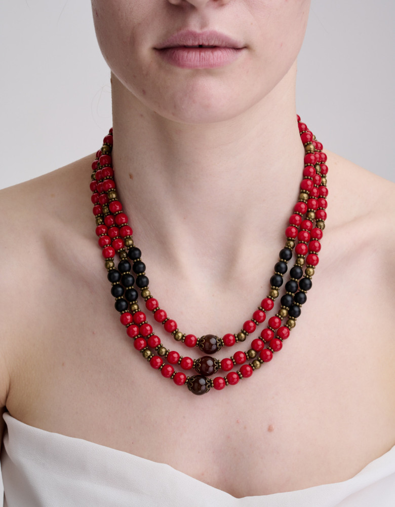 The necklace is red and black in three rows